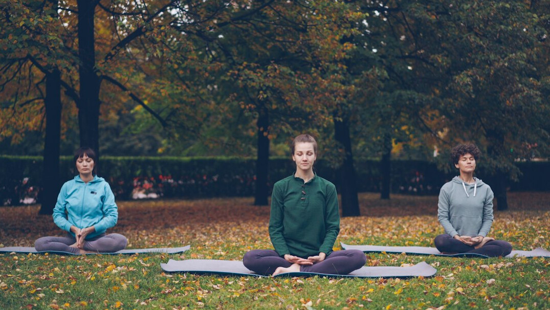 person meditating in nature
